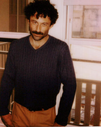 Hogan Ellis standing on a balcony in the definitive Kingdom of Forgetting press portrait